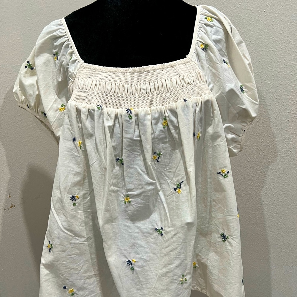Plus size top with little blue and yellow flowers.